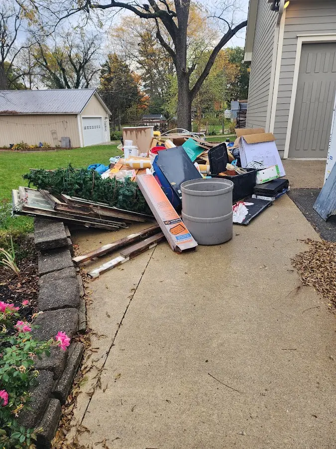 Dumpster being loaded with debris for 12 Yard Dumpster Rental in Bunkie